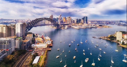 Capture the reflective waters surrounding Sydney with a picturesque view from the Sydney Harbour Bridge