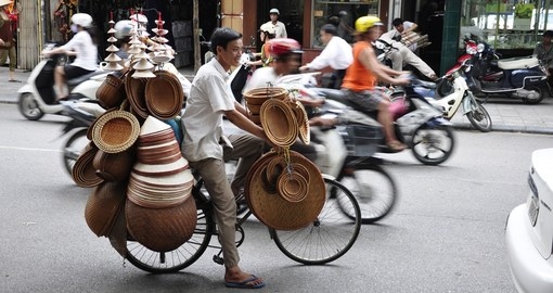 A hat salesman in the busy Hanoi traffic