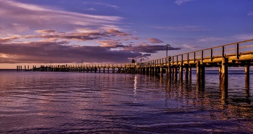 Experience sunset at the jetty at Kingfisher Bay Resort during your next Australia tours.