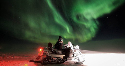 Seeing the Northern Lights on a snowmobile safari is a highlight of your Finland holiday.