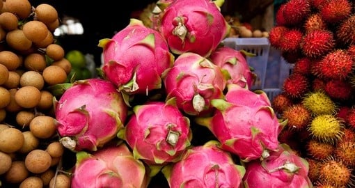 A Colorful Pile of Dragon Fruit in a Street Market