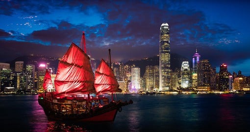 Capture the beauty of junk boats sailing through the Victoria Harbour