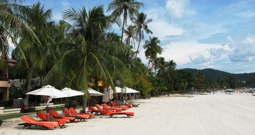 Enjoy comfort and relaxation on one of Langkawi's white sand beaches on your trip to Malaysia