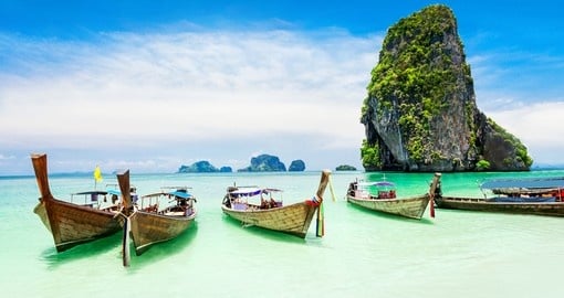 Check out the traditional boats that line the beaches in Phuket on your Thailand Vacation