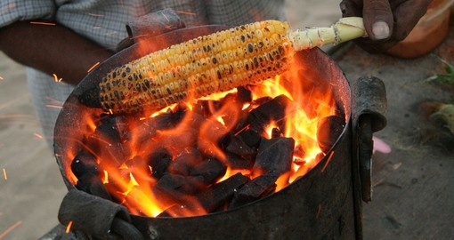 Roasting corn on Chowpatty Beach