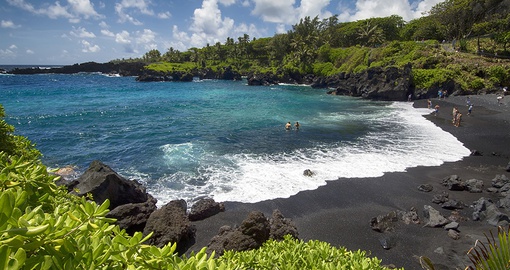 Drive down to the black sand beach right off the Road to Hana for a one in a lifetime experience!