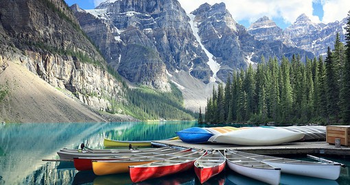 Experience the vibrant colours of Moraine Lake and its surrounding mountains
