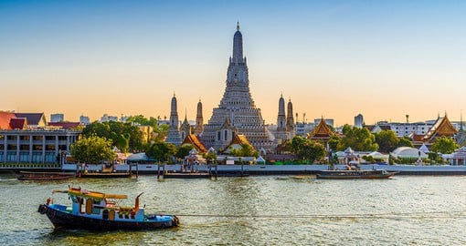 Explore Bangkok's riverside temple of Wat Arun, known for its stunning spires