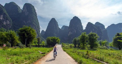 Experience the dramatic landscape of limestone hills around Guilin on a leisure ride