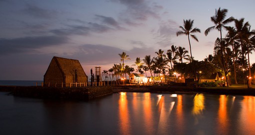 Enjoy a luau, a traditional Hawaiian feast with entertainment, while the sun sets in the background