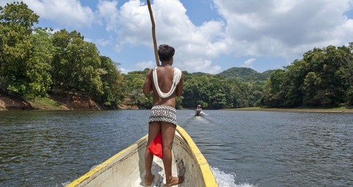 Traditional Embera Indian on long boat at Gambia