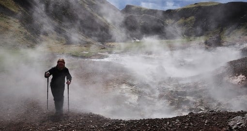 A Young Woman Hiking through a Geothermal Area