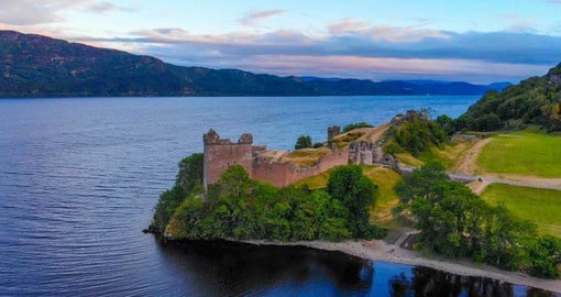 The ruins of Urquhart Castle sit on the shores of Loch Ness