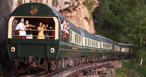 Feel the rushing air as you stand in the windowless back carriage of the Eastern and Oriental Train on your Asia Travel