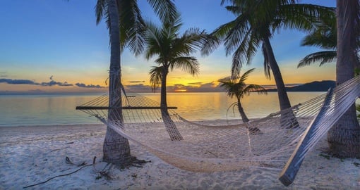 Fiji beach sunset with hammock