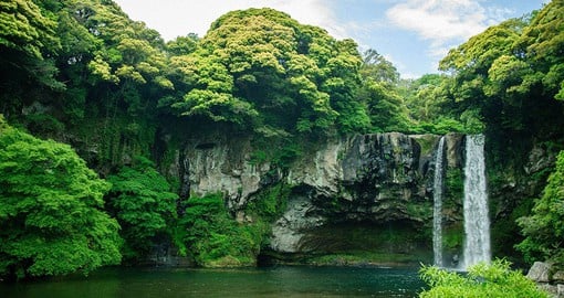 Venture to Jeju Island, housing lush forests, tall mountains, and endless waterfalls