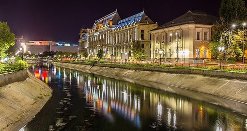 Walk along the water while admiring the Palace of Justice in Bucharest