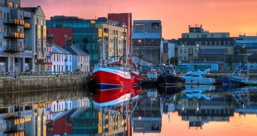 Enjoy the beautiful night view of Galway when boats are resting at the docks on your next Ireland tours.