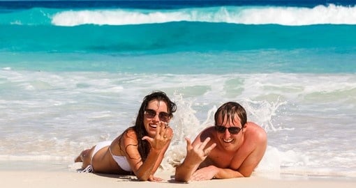 Enjoying sun, sand and surf on La Digue island on your Seychelles vacation.