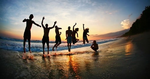 Jumping on the beach at sunset