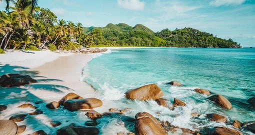 Kick back on the beach of Mahe Island, the largest of The Seychelles covered in sand, stones, and lush vegetation