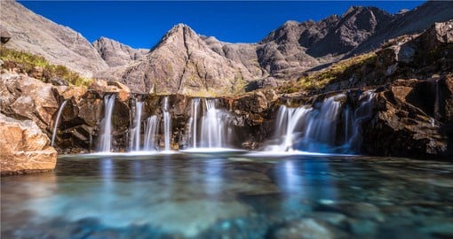 One of the must see places on  your next England vacation is Fairy Pools on the Isle of Sky.