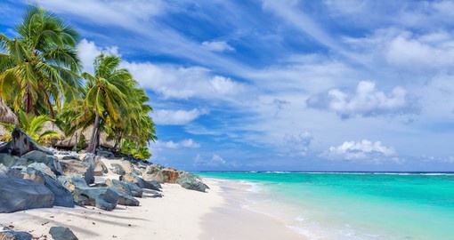 Experience tranquility on one of the beautiful white sand beaches of Rarotonga