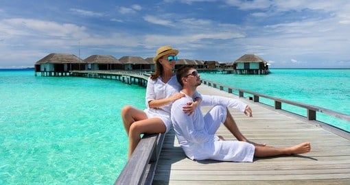 Couple on a beach jetty at Maldives