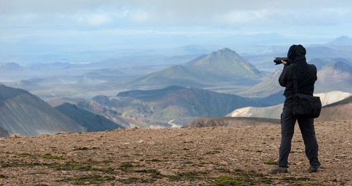 Photographer taking picture of Landmannalaugar Mountains