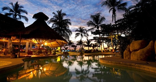 Evening picture of the swimming pool area at a resort