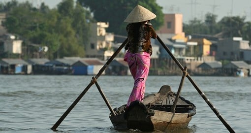 Women rowing boat at Mekong delta