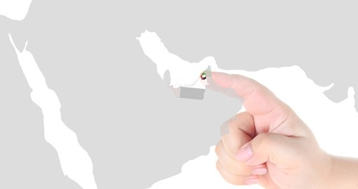 Finger touch on map of Dubai