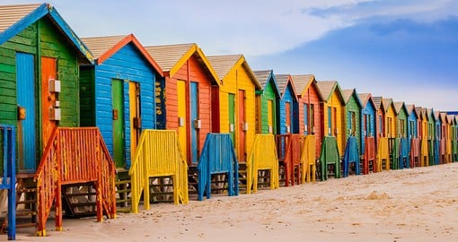 Hit the beach in Cape Town, stopping to change in a colourful bathing hut