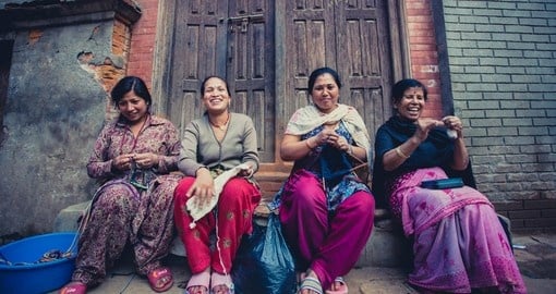 Women in Bhaktapur smiling and working in the street