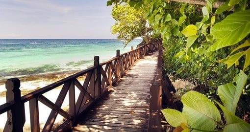 Walk along the wooden pathway right on the beach and enjoy the natural scenery on your Malaysia Vacation