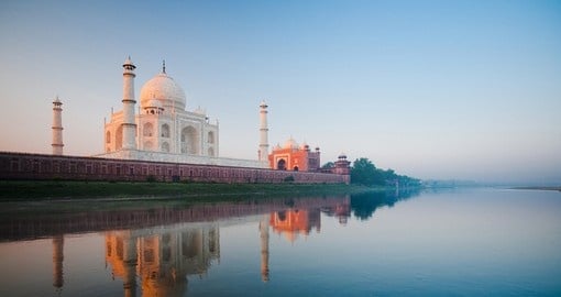 A beautiful sunrise lights the side of the Taj Mahal