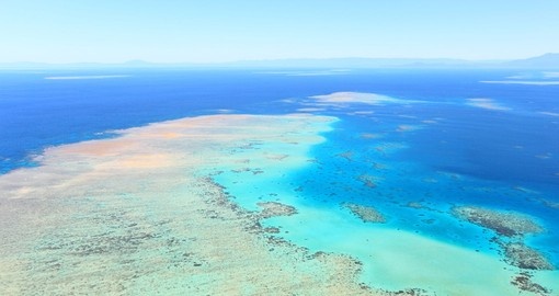 Explore the view of the Great Barrier Reef from the air during your next Australia vacations.
