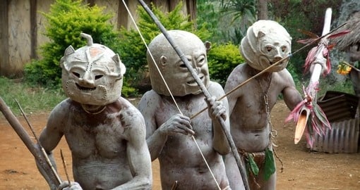 Mudmen warriors clasp their weapons at the Goroka Tribal Festival