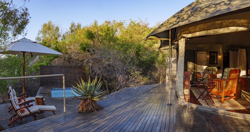 The tents blend into the natural landscape and are linked by walkways and paths through the bush