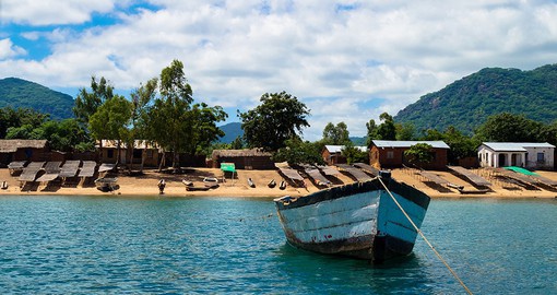 Set sail on Lake Malawi, enjoying the blue waters against the lush green mountains