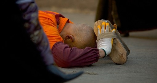 Tibetan Buddhist monk in full ground prostration