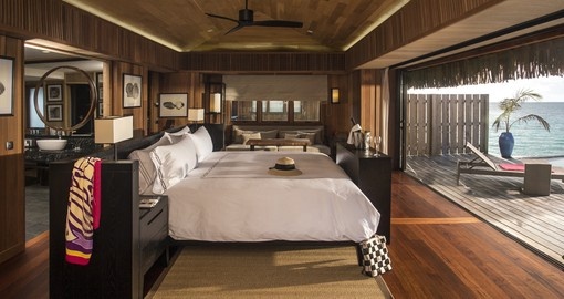 The interior of an overwater bungalow at Conrad Bora Bora Nui is a great sight to wake up to on your Bora Bora Vacations.