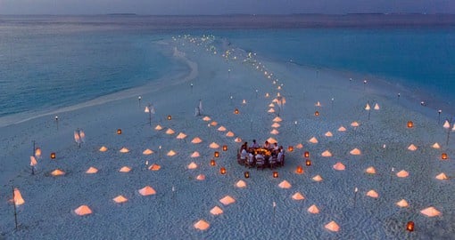 Enjoy dinner on the Maldives' signature white-sand beaches