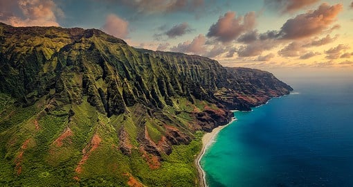 Combine the stunning sights of cliffs, coast, and colossal waterfalls at Na Pali Coast in Kauai