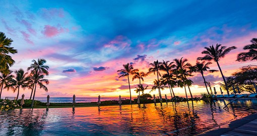 Relax by the water to capture the stunning colours of the Waikiki sunset