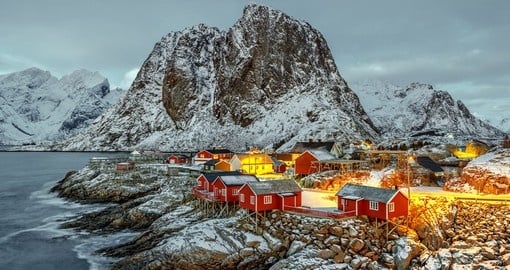 Match majestic mountains with white sandy beaches on the Lofoten Islands, a popular fishing spot in Norway