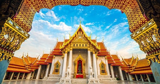 Enter the golden doors of the Wat Benchamabophit temple, better known as Bangkok's Marble Temple