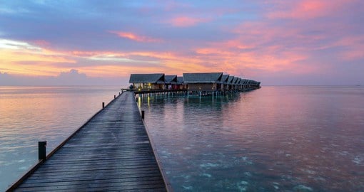 A gorgeous sunset view of the luxurious Ocean Villas at the Adaaran Select Hudhuran Fushi Resort