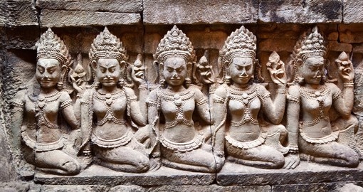 See ancient stone carvings on your trip to Cambodia