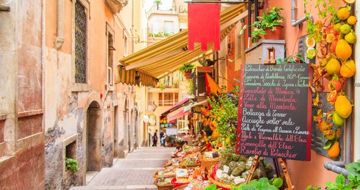 Explore Taormina's narrow streets and traditional shops